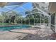 Screen enclosed pool and spa area with brick pavers and ample space for lounging by the pool at 1155 Collins Ave, Orange City, FL 32763