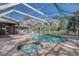 A screen-enclosed pool and spa featuring a brick paver surround, providing a luxurious outdoor experience at 1155 Collins Ave, Orange City, FL 32763