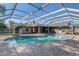 Enjoy the outdoors with this in-ground pool, spa, and screened enclosure, perfect for year-round enjoyment and entertaining at 1155 Collins Ave, Orange City, FL 32763
