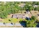 The aerial view captures the home nestled amongst mature trees with a lush green lawn at 117 Orange Ridge Dr, Longwood, FL 32779