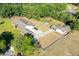 Sprawling property featuring a well-maintained home, outbuildings, lush greenery and mature trees at 117 Orange Ridge Dr, Longwood, FL 32779