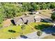 Aerial view of a charming single-story home with a well-manicured lawn surrounded by lush trees at 117 Orange Ridge Dr, Longwood, FL 32779