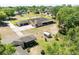 An aerial shot features the home and a detached garage surrounded by mature trees at 117 Orange Ridge Dr, Longwood, FL 32779