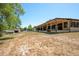 Large backyard showcasing a covered patio and lush greenery, perfect for outdoor activities and relaxation at 117 Orange Ridge Dr, Longwood, FL 32779