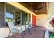 Charming covered porch with outdoor seating and a ceiling fan, perfect for relaxing and enjoying the view at 117 Orange Ridge Dr, Longwood, FL 32779