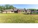 View of a large ranch-style house with a red brick walkway and a well-kept lawn under a clear blue sky at 117 Orange Ridge Dr, Longwood, FL 32779