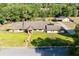 An aerial shot showcases the home's front yard, charming brick walkway, and manicured lawn at 117 Orange Ridge Dr, Longwood, FL 32779