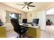 Bright home office featuring a large window, ceiling fan, and a spacious desk setup for productivity at 117 Orange Ridge Dr, Longwood, FL 32779