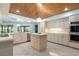 Updated kitchen with island, stainless appliances, and wooden ceiling; great layout for cooking at 117 Orange Ridge Dr, Longwood, FL 32779