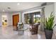 Bright living room featuring tile flooring, decorative curtains, and large windows offering views of the landscaped exterior at 117 Orange Ridge Dr, Longwood, FL 32779