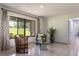 Bright living room featuring tile flooring, decorative curtains, and large windows offering views of the landscaped exterior at 117 Orange Ridge Dr, Longwood, FL 32779