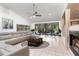 Spacious living room with tile floors, a comfortable sectional sofa, and a fireplace, perfect for cozy evenings at 117 Orange Ridge Dr, Longwood, FL 32779