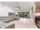 Spacious living room with tile floors, a comfortable sectional sofa, and a fireplace, perfect for cozy evenings at 117 Orange Ridge Dr, Longwood, FL 32779