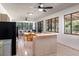 Open-concept living area with an eat-in dining table, comfortable seating area, and large windows with natural light at 117 Orange Ridge Dr, Longwood, FL 32779