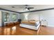 Bright main bedroom with wood floors, a ceiling fan, and a comfortable bed with stylish decor at 117 Orange Ridge Dr, Longwood, FL 32779