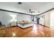 Bright main bedroom with wood floors, a ceiling fan, and a comfortable bed with stylish decor at 117 Orange Ridge Dr, Longwood, FL 32779