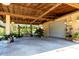 Spacious covered area with lush greenery, a bench, and ample space for parking or entertaining at 117 Orange Ridge Dr, Longwood, FL 32779