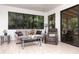 Cozy sunroom with large windows providing natural light, comfortable seating, and serene views of the outdoors at 117 Orange Ridge Dr, Longwood, FL 32779