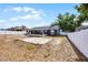 Spacious backyard with a white fence, patio area, and potential for landscaping or outdoor activities at 15532 Kensington Trl, Clermont, FL 34711