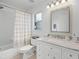 Bright bathroom featuring a shower/tub combo, modern vanity, and neutral color palette at 15532 Kensington Trl, Clermont, FL 34711