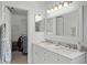 Bathroom featuring double sinks, marble countertops, and ample cabinet space at 15532 Kensington Trl, Clermont, FL 34711