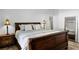 Bedroom with a wooden bed frame, wood floors, and a mirrored closet at 15532 Kensington Trl, Clermont, FL 34711