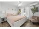 Bedroom featuring a large white bed, soft pink bedding, and natural light at 15532 Kensington Trl, Clermont, FL 34711