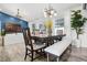 Open-concept dining room features a modern table, accent wall and bright natural light at 15532 Kensington Trl, Clermont, FL 34711