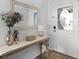Bright entryway with decorative mirror, accent table, and glass-paneled front door at 15532 Kensington Trl, Clermont, FL 34711