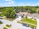 Charming single-story home featuring a well-manicured lawn and a spacious driveway, marked by a red boundary line at 15532 Kensington Trl, Clermont, FL 34711