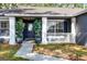 Inviting front porch featuring decorative plants and a pathway leading to the front door at 15532 Kensington Trl, Clermont, FL 34711