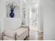 Hallway featuring an elegant bench and decor leading to the stylish bathroom at 15532 Kensington Trl, Clermont, FL 34711
