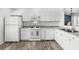 Well-lit kitchen featuring wood-look flooring, modern appliances, and ample cabinet space at 15532 Kensington Trl, Clermont, FL 34711