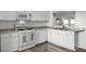 Well-lit kitchen featuring wood-look flooring, modern appliances, and ample cabinet space at 15532 Kensington Trl, Clermont, FL 34711