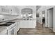 Bright kitchen with modern countertops, white cabinets, and updated appliances, next to dining room at 15532 Kensington Trl, Clermont, FL 34711