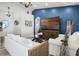 Inviting living room with bright accent wall, modern furniture, and a decorative chandelier at 15532 Kensington Trl, Clermont, FL 34711