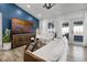 Bright living room featuring white furniture, accent wall, and French doors at 15532 Kensington Trl, Clermont, FL 34711