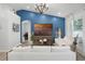 Modern living room with accent wall, wood floors, and decorative lighting fixtures at 15532 Kensington Trl, Clermont, FL 34711