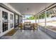 Relaxing screened patio with tile flooring and outdoor seating, great view of backyard at 15532 Kensington Trl, Clermont, FL 34711