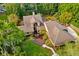 Aerial perspective of a home with a sprawling roof, deck, and mature trees at 1555 Waterwitch Dr, Orlando, FL 32806