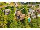 Aerial view showcasing the property's circular driveway, well-maintained landscaping, and a pool at 1555 Waterwitch Dr, Orlando, FL 32806