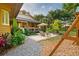 Lush backyard featuring a patio, seating, playset, and meticulously maintained landscaping at 1555 Waterwitch Dr, Orlando, FL 32806