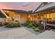 Beautifully landscaped backyard with a patio, lush plants, and inviting home exterior at sunset at 1555 Waterwitch Dr, Orlando, FL 32806