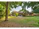 Expansive backyard featuring a playground, mature trees, and a screened-in porch perfect for outdoor enjoyment at 1555 Waterwitch Dr, Orlando, FL 32806