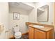 Powder room featuring granite countertops, tile floors and a modern mirror and light fixture at 1555 Waterwitch Dr, Orlando, FL 32806
