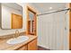 Bathroom with granite countertops, a sink and a walk-in shower with a white shower curtain at 1555 Waterwitch Dr, Orlando, FL 32806