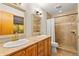 Bathroom featuring double sinks with granite countertop and a walk-in shower with a white shower curtain at 1555 Waterwitch Dr, Orlando, FL 32806