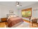Bright bedroom features hardwood floors, a ceiling fan, and a large window with a backyard view at 1555 Waterwitch Dr, Orlando, FL 32806