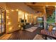 Cozy covered patio with comfortable seating, string lights, and a view of the lush backyard at 1555 Waterwitch Dr, Orlando, FL 32806