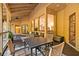 Charming covered patio featuring outdoor dining and lounge area with backyard views at 1555 Waterwitch Dr, Orlando, FL 32806